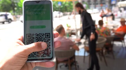 Europe, Italy ,  Milan, July 2021  Green Pass European Eu Digital Covid-19 passport Certificate to travel - tourists in downtown of the city  - Powered by Adobe