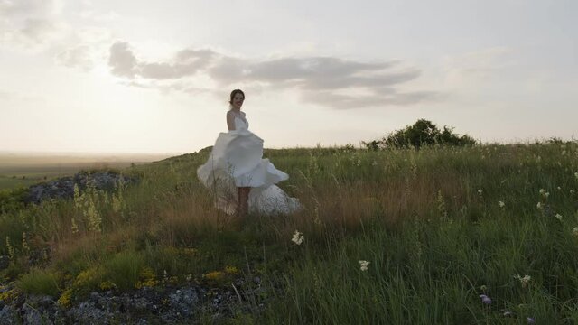Back side view of beautiful bride in white dress