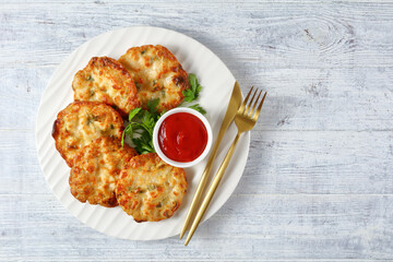 Cheesy Chicken Fritters on a plate, top view