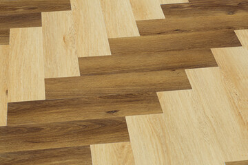 Laminate and parquet with herringbone background. Wooden floor with a chevron pattern in the living room of the designer interior