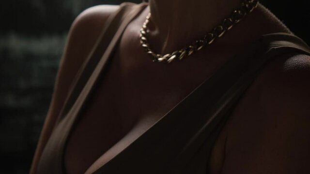 Sexy blonde with a gold chain and luxurious earrings.