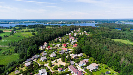 A small town by the river on a sunny and beautiful summer day. View from the top.