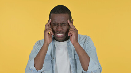 Young African Man having Headache, Yellow Background 