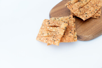 Fried crispbread on cutting board on white background