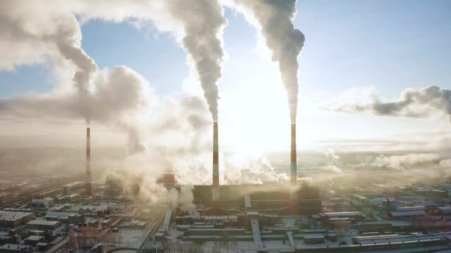 power plant pipes on the background of the panorama of the winter city Kirov against blue sky.