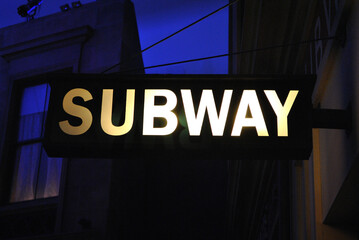 Close Up of Illuminated 'Subway' Sign on Public Display at Night
