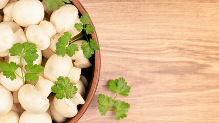 fresh mini champignons and parsley leaves in a plate
