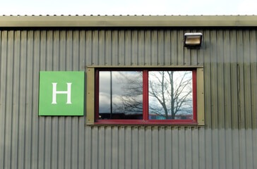 Corrugated Wall of Industrial Building with Window & Letter H 