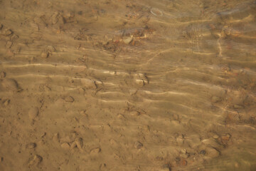 Sandy beach. River sand. Small waves on the river