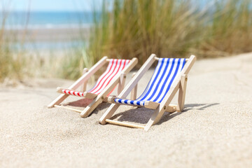 Fototapeta na wymiar Summer beach vacation, two deck chairs