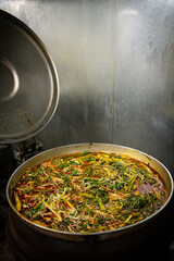 Boil the meat soup in a large pot.