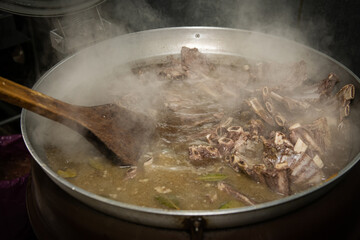 Boil the meat soup in a large pot.