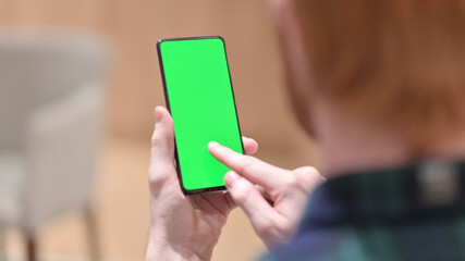 Redhead Man Using Smartphone with Green Chroma Screen 