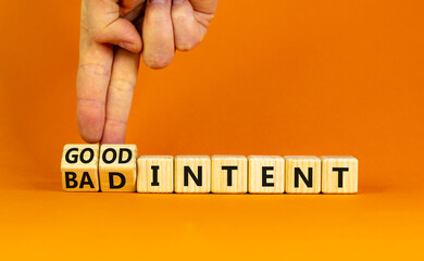 Good or bad intent symbol. Businessman turns wooden cubes and changes words 'bad intent' to 'good...