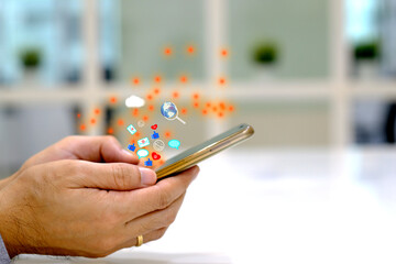 A businessman holding a smartphone and surfing internet and networking social media. Surfing internet concept.