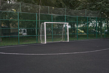 A soccer goal with a net on the court.