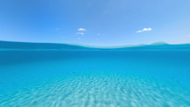Split-shot, over-under shot. Stunning view of half underwater half sky with a beautiful and turquoise water. Liscia Ruja, Sardinia, Italy.