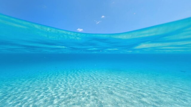 Split-shot, over-under shot. Stunning view of half underwater half sky with a beautiful and turquoise water. Liscia Ruja, Sardinia, Italy.
