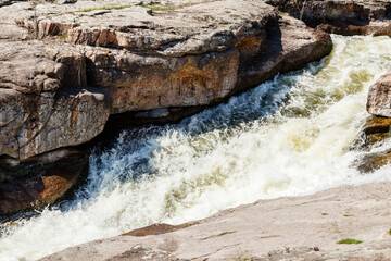 flow of water and spray from a stone