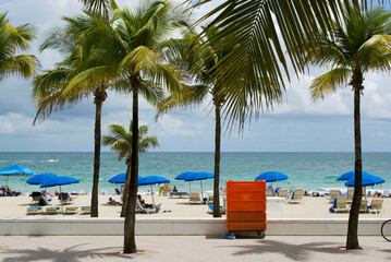 Locals and tourists enjoying sunbathing on the beach of Fort Lauderdale, Florida, USA - obrazy, fototapety, plakaty