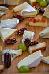 cheese plate with nuts and grapes 