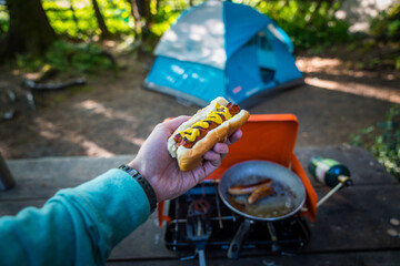 Preparing hot dogs outdoors camping