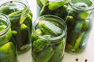 The process of canning cucumbers for the winter, pickled vegetables in glass jars close-up