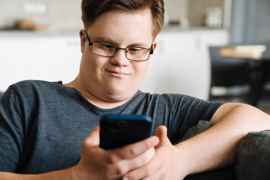 Smiling white young man with down syndrome