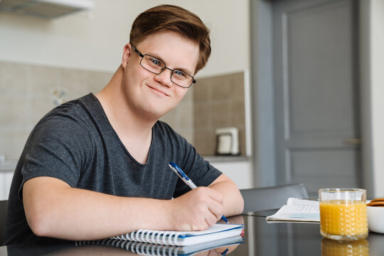 Smiling white young man with down syndrome
