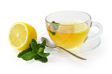 Tea with mint and lemon in glass cup on saucer