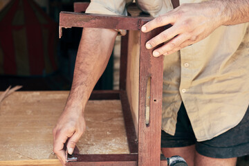 Man assembling furniture and fixing it - hobby concept.