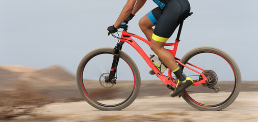 Motion blur of a mountain bike race with the bicycle and rider at high speed.Bike panning shot