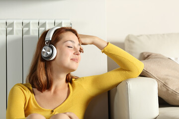 Relaxed woman on radiator listening to music