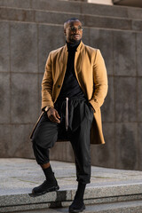 Black model posing wearing elegant stylish suit. urban lifestyle