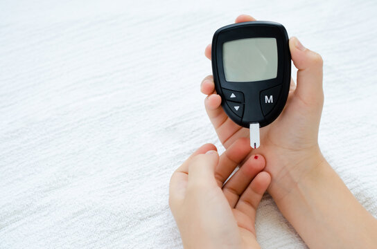 Diabetes Test. Child Hands Checking Blood Sugar Level By Glucose Meter.