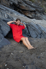 Stylish young woman in a vintage red dress of sixties lifestyle.