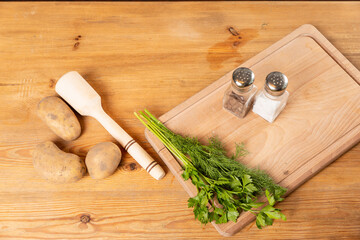 Coocking potatoes and green in kitchen