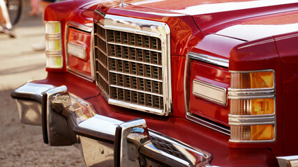 Red retro car. Old vintage car. Headlight close up. Exhibition of retro cars.