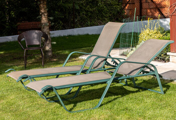 Two loungers in the garden in front of the terrace