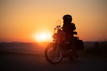 Fototapeta na wymiar Driver riding motorcycle on an empty road