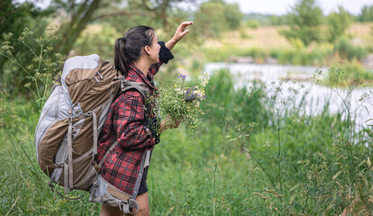 A girl on a hike with a large tourist backpack.