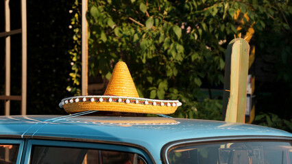 Roof of a blue retro car. Mexican hat on the roof of the car. Exhibition of retro cars