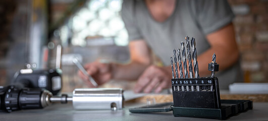 Close-up set of wood drills on a blurred background.