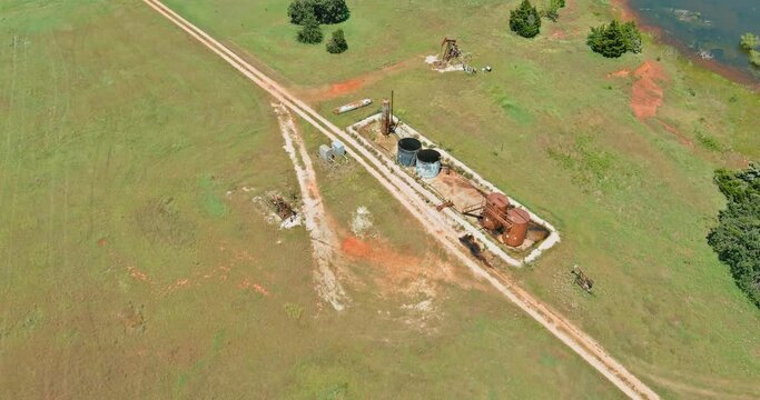 Panoramic view pump jack on the of oil-gas pump jack out in field behind Oklahoma USA