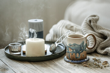 Home scandinavian style still life with a cup of tea and candles.