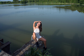 Girl on the shore of the pond