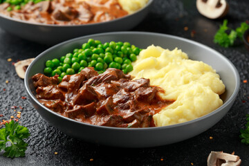 Slow Cooked Steak Diane Casserole with mushroom. mashed potatoes and green peas