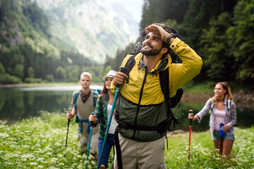 Group of young friends hiking in countryside. Multiracial happy people travelling