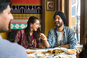 A group of Indian people is having lunch together