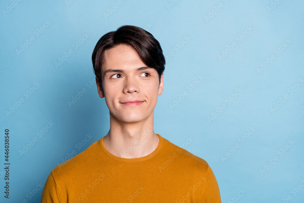 Sticker Photo of funny brunet young man look empty space wear brown sweater isolated on blue color background